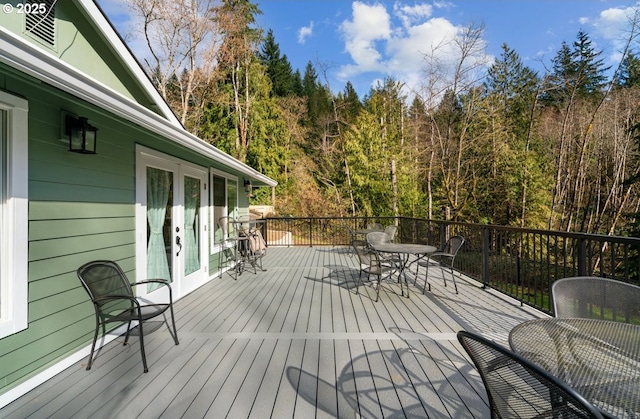 deck with outdoor dining space and french doors