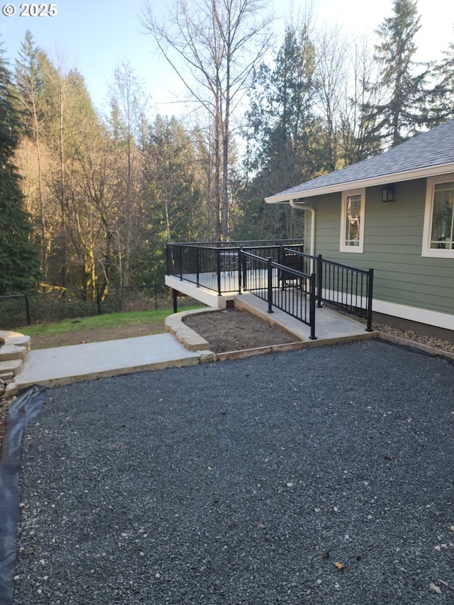 view of yard featuring a patio and a wooden deck