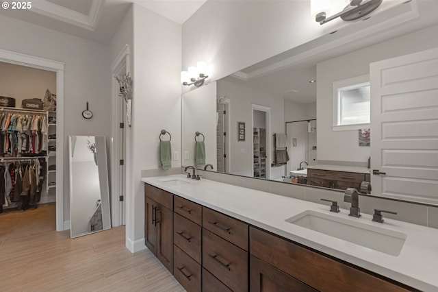 5786 NW Hood Loop, Camas, WA 98607 - full bath featuring a walk in closet, double vanity, a stall shower, wood finished floors, and baseboards