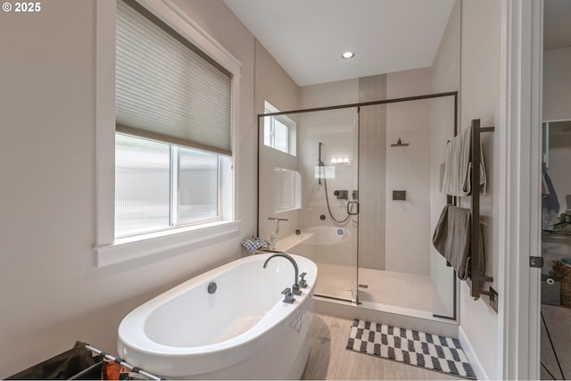 5786 NW Hood Loop, Camas, WA 98607 - bathroom with a soaking tub, a shower stall, and wood finished floors
