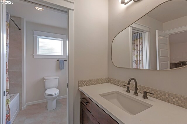 5786 NW Hood Loop, Camas, WA 98607 - bathroom featuring toilet, vanity, shower / bath combo with shower curtain, and tile patterned floors