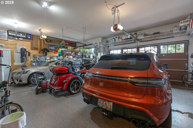 5786 NW Hood Loop, Camas, WA 98607 - garage with wood walls, a garage door opener, and a central vacuum unit
