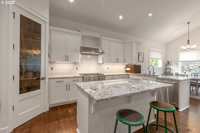5786 NW Hood Loop, Camas, WA 98607 - kitchen featuring stainless steel appliances, a sink, a peninsula, range hood, and dark wood finished floors