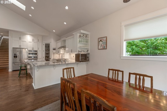 5786 NW Hood Loop, Camas, WA 98607 - dining area with dark wood finished floors, a skylight, vaulted ceiling, and recessed lighting