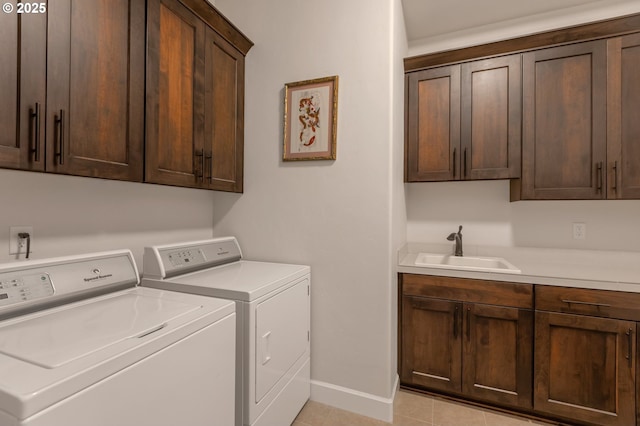 5786 NW Hood Loop, Camas, WA 98607 - washroom featuring washing machine and clothes dryer, cabinet space, baseboards, and light tile patterned floors