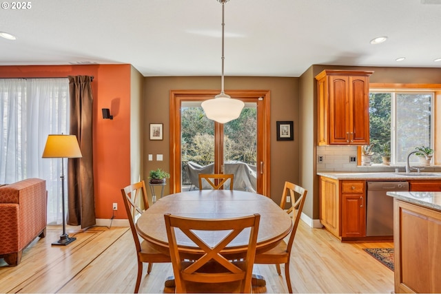 dining room featuring recessed lighting, baseboards, and light wood finished floors