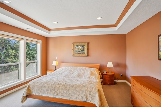 bedroom featuring baseboards, a raised ceiling, carpet, and crown molding