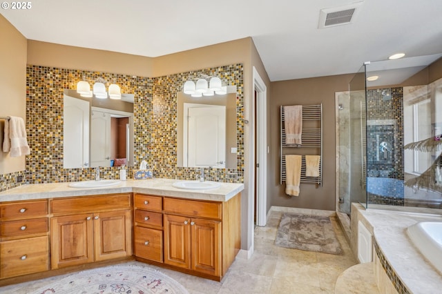 bathroom featuring a shower stall, tasteful backsplash, visible vents, and a sink