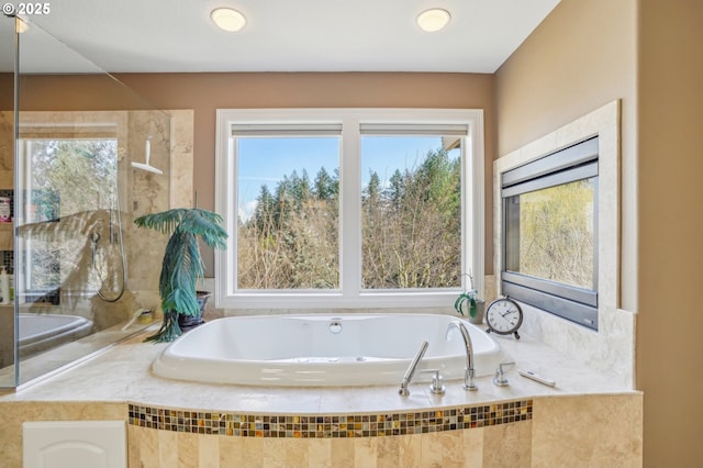 full bath featuring plenty of natural light and a bath