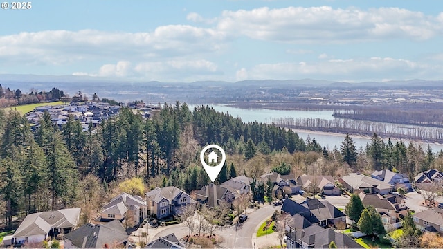 drone / aerial view featuring a water view and a residential view