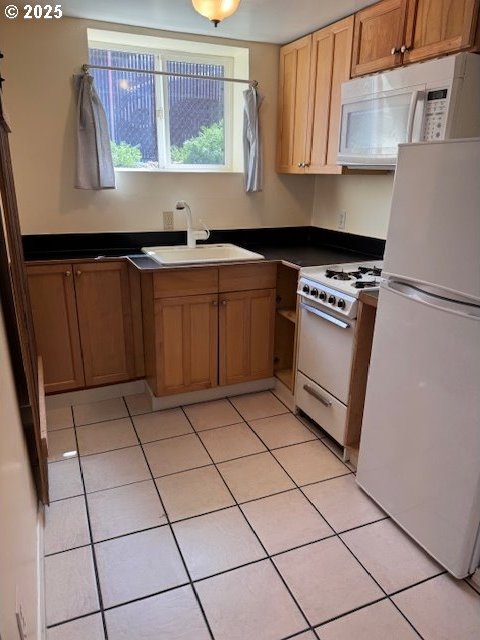 6308 SE 93rd Ave, Portland, OR 97266 - kitchen with a sink, dark countertops, light tile patterned floors, and white appliances