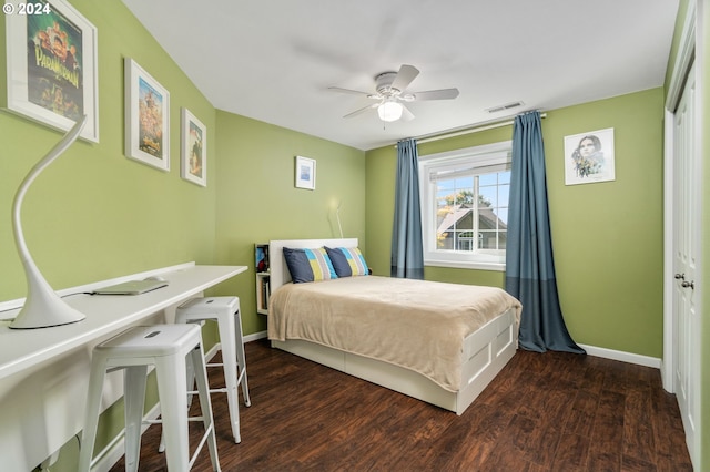 bedroom featuring visible vents, a ceiling fan, baseboards, and wood finished floors