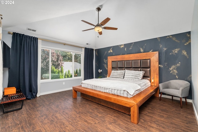 bedroom featuring wallpapered walls, vaulted ceiling, wood finished floors, and baseboards