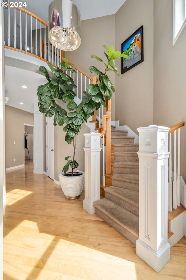 stairs featuring recessed lighting, baseboards, and wood finished floors