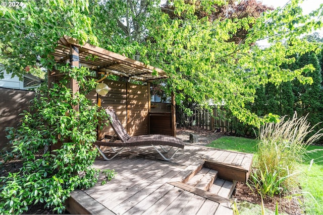 deck with a pergola and fence