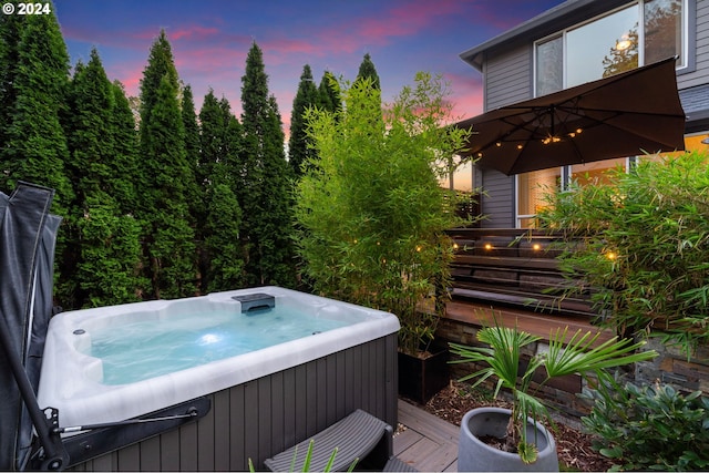 wooden deck with a hot tub