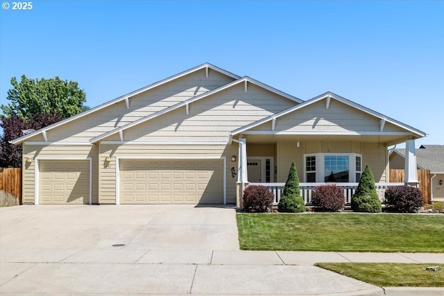 853 NE Cobblestone Ct, Prineville, OR 97754 - craftsman house featuring driveway, a garage, a front lawn, and covered porch