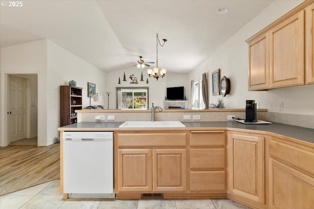 853 NE Cobblestone Ct, Prineville, OR 97754 - kitchen with white dishwasher, a sink, light brown cabinetry, a peninsula, and vaulted ceiling