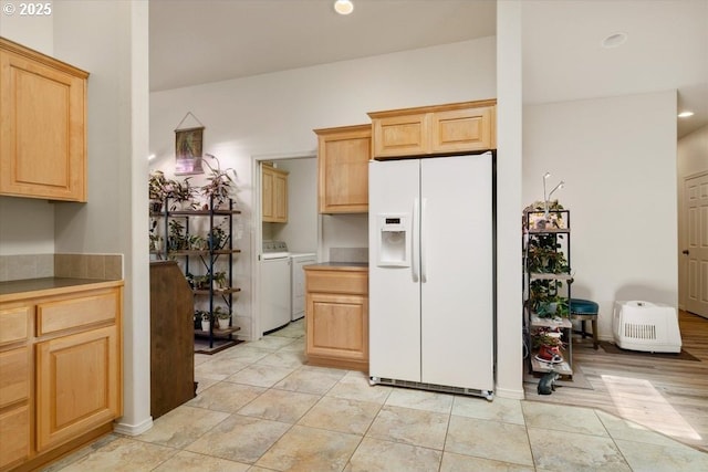 853 NE Cobblestone Ct, Prineville, OR 97754 - kitchen featuring white fridge with ice dispenser, washing machine and clothes dryer, light brown cabinetry, and recessed lighting