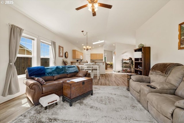 853 NE Cobblestone Ct, Prineville, OR 97754 - living room with a ceiling fan, lofted ceiling, a chandelier, light wood-style floors, and recessed lighting