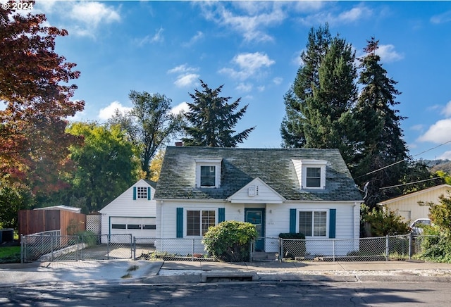1772 SE Hamilton St, Roseburg, OR 97470 - cape cod-style house featuring a fenced front yard, a garage, concrete driveway, and a gate