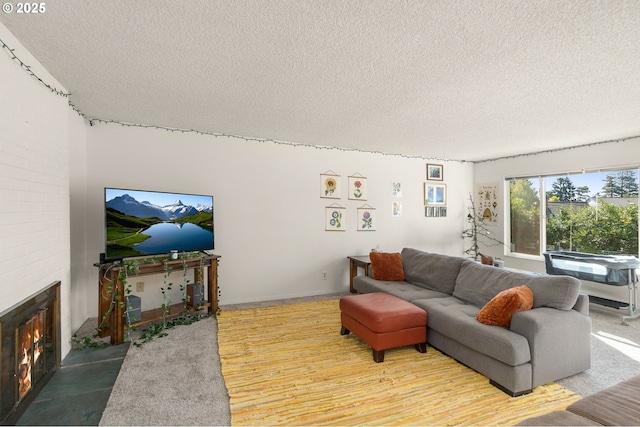 living room featuring a fireplace and a textured ceiling