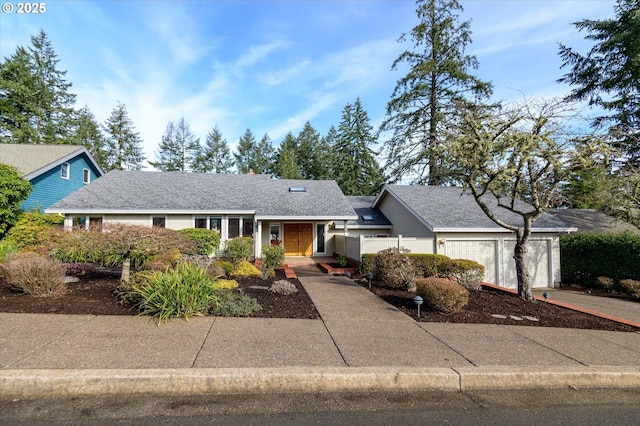 ranch-style house with an attached garage and concrete driveway