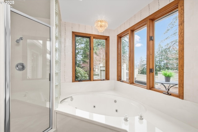 bathroom featuring a whirlpool tub, an inviting chandelier, a shower stall, and wallpapered walls