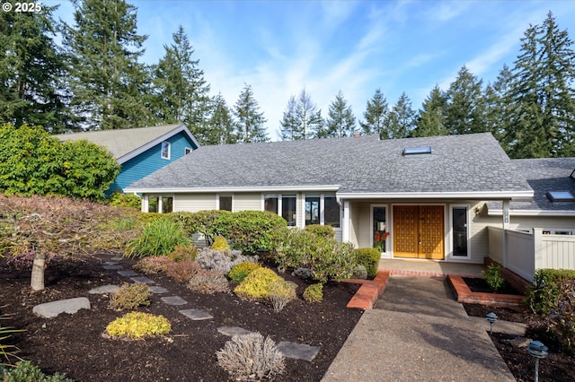 view of front of house featuring fence, a porch, and roof with shingles