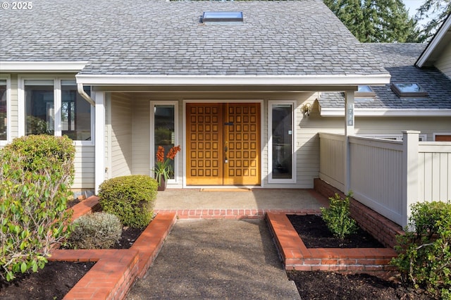 entrance to property featuring fence