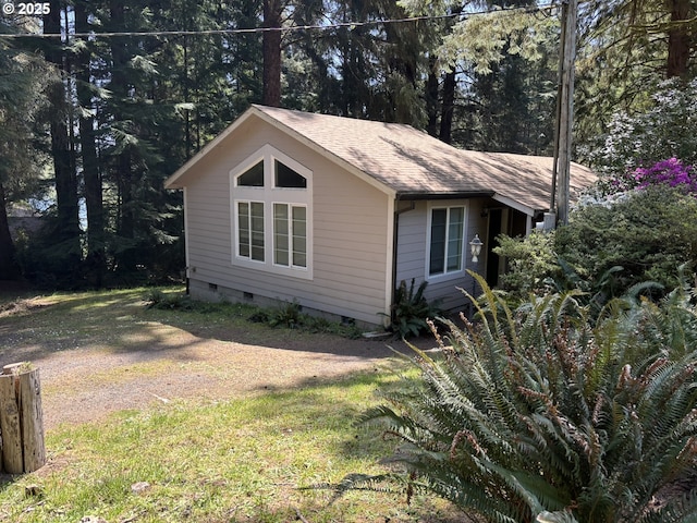 5336 Buckskin Bob, Florence, OR 97439 - view of side of home with a shingled roof, crawl space, and a lawn