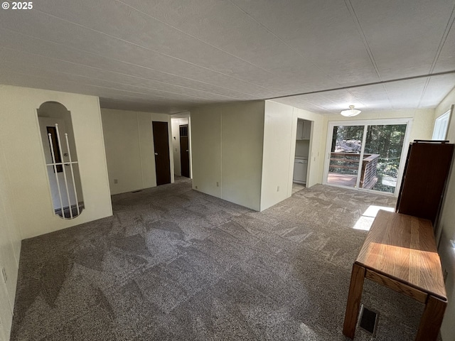 5336 Buckskin Bob, Florence, OR 97439 - unfurnished living room featuring arched walkways and carpet