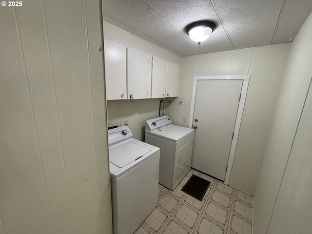 5336 Buckskin Bob, Florence, OR 97439 - laundry room featuring a textured ceiling, light floors, washer and dryer, and cabinet space