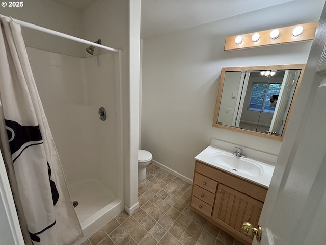 5336 Buckskin Bob, Florence, OR 97439 - full bathroom featuring vanity, baseboards, toilet, and a stall shower