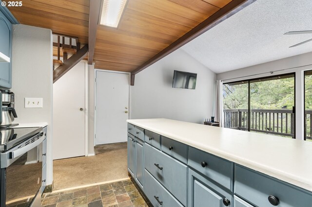 kitchen with stainless steel electric stove, blue cabinets, white refrigerator, light carpet, and beam ceiling