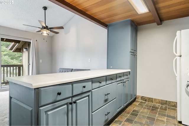 kitchen featuring wood ceiling, white refrigerator, a textured ceiling, kitchen peninsula, and beamed ceiling