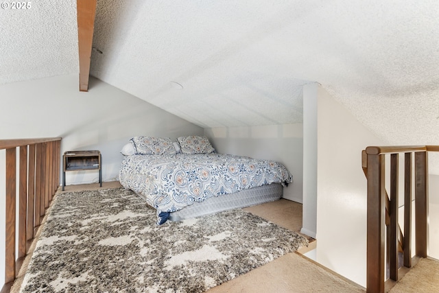 carpeted bedroom with a textured ceiling and vaulted ceiling with beams