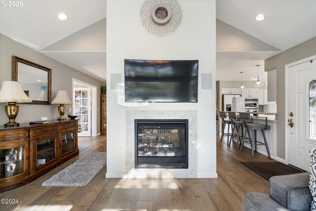 465 SW Edgewater, Depoe Bay, OR 97341 - living area with a multi sided fireplace, wood finished floors, recessed lighting, baseboards, and high vaulted ceiling