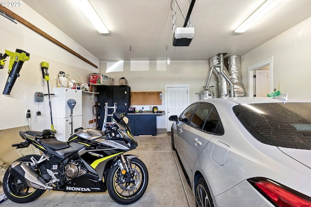 3647 Lodenquai Ln, Eugene, OR 97404 - garage with a garage door opener and water heater