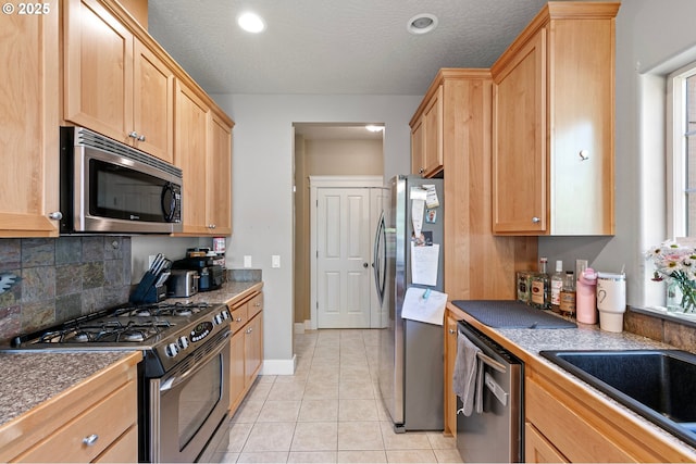 3647 Lodenquai Ln, Eugene, OR 97404 - kitchen featuring stainless steel appliances, light brown cabinets, light tile patterned floors, decorative backsplash, and recessed lighting