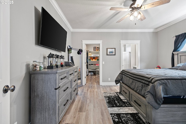 3647 Lodenquai Ln, Eugene, OR 97404 - bedroom featuring a spacious closet, light wood-style flooring, ornamental molding, baseboards, and ceiling fan