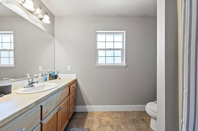 3647 Lodenquai Ln, Eugene, OR 97404 - bathroom with baseboards, vanity, and toilet