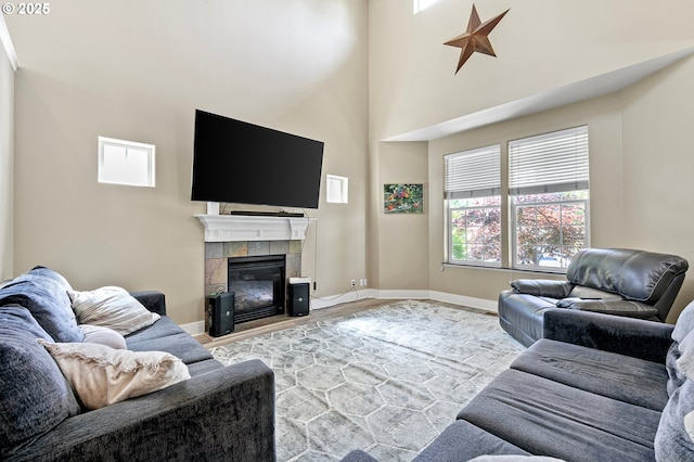 3647 Lodenquai Ln, Eugene, OR 97404 - living area with wood finished floors, a fireplace, baseboards, and a towering ceiling