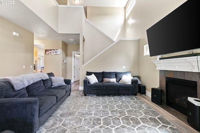 3647 Lodenquai Ln, Eugene, OR 97404 - living room featuring wood finished floors, a fireplace, stairway, and baseboards