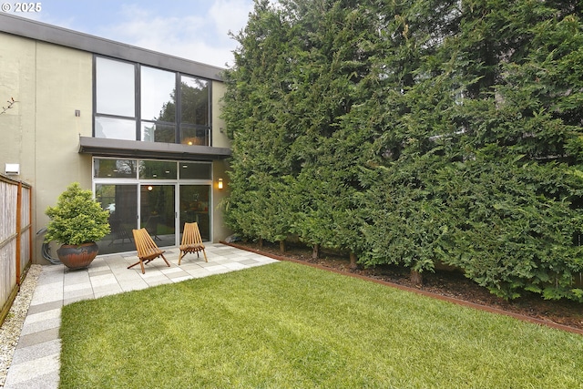 rear view of house featuring a yard and a patio area