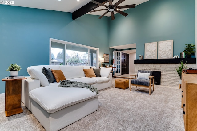 2915 Chuckanut St, Eugene, OR 97408 - carpeted living room with ceiling fan, beamed ceiling, a fireplace, and high vaulted ceiling