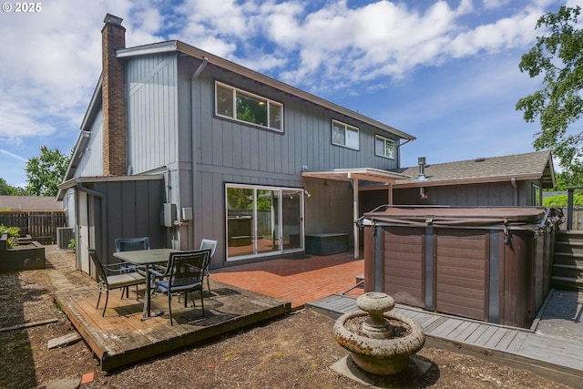 2915 Chuckanut St, Eugene, OR 97408 - back of house featuring a hot tub, a deck, a chimney, and outdoor dining area