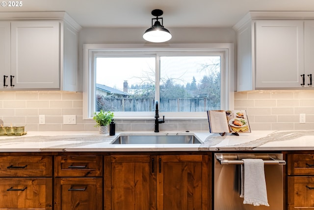2915 Chuckanut St, Eugene, OR 97408 - kitchen featuring stainless steel dishwasher, white cabinets, and tasteful backsplash