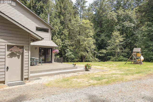 view of yard featuring a deck and a playground