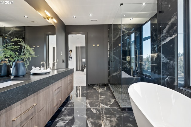 bathroom featuring separate shower and tub and vanity